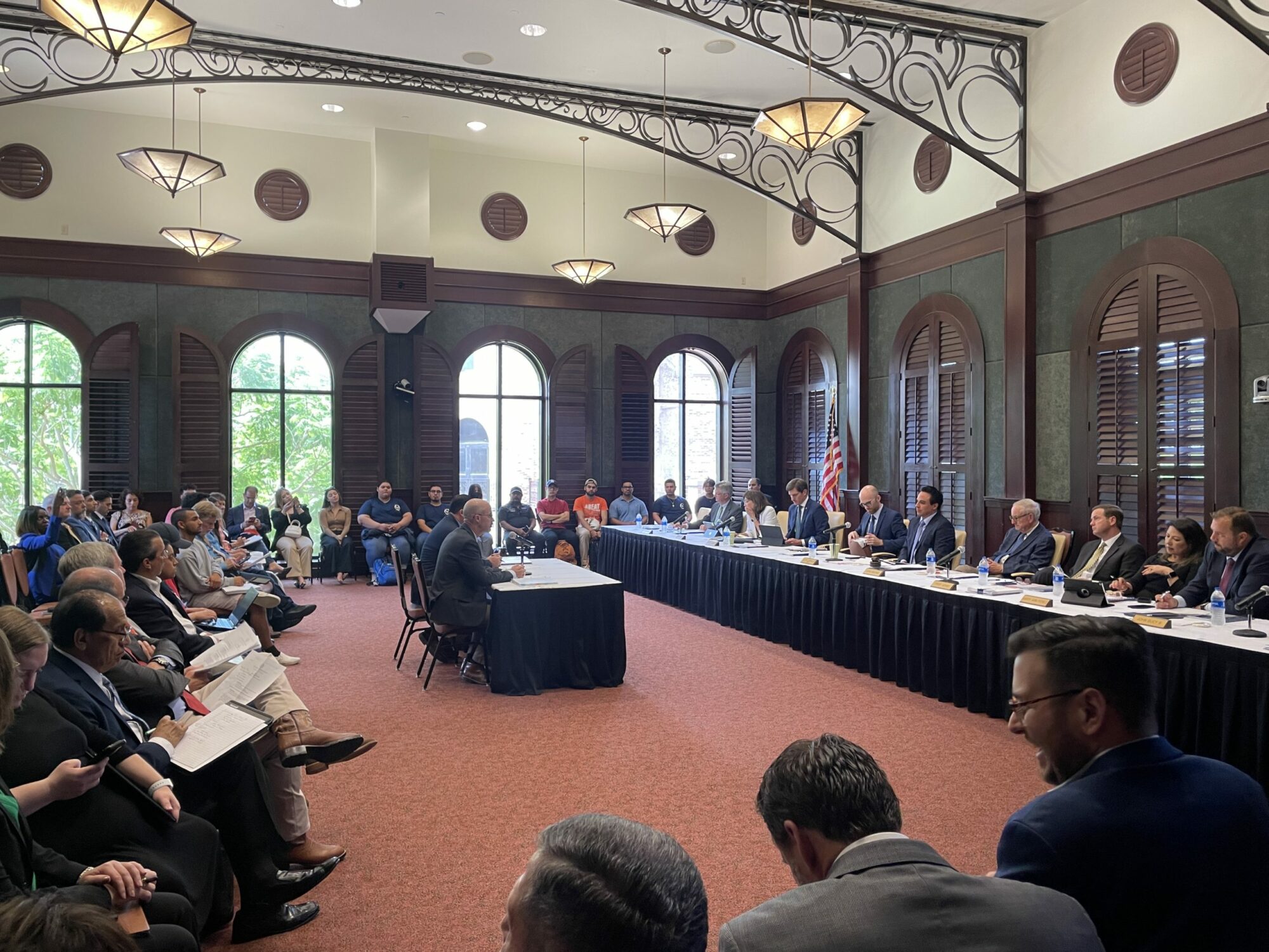 A nice room at the UT RGV Brownsville campus set up for a hearing of the Texas House Committee on Transportation. The committee is to the right chaired by Terry Canales and the crowd is to the left, with TxDOT CEO Marc Williams sitting at the witness table facing the committee.